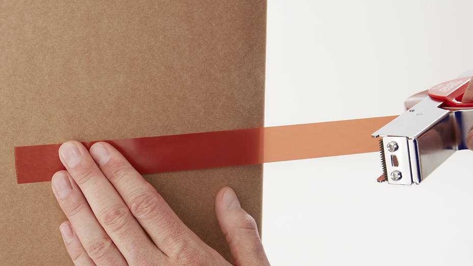 Applying Orange Strapping Tape 4287 on Cardboard Box