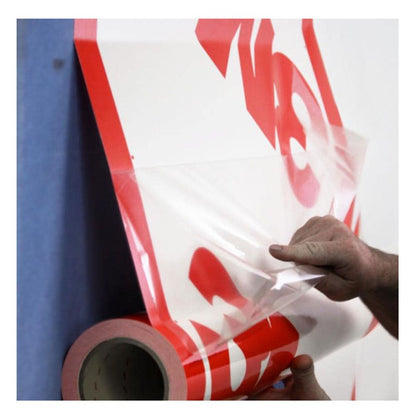 Close-up of a contractor peeling the clear release liner from the aggressive adhesive side of the 3M 3015VP vapour permeable membrane