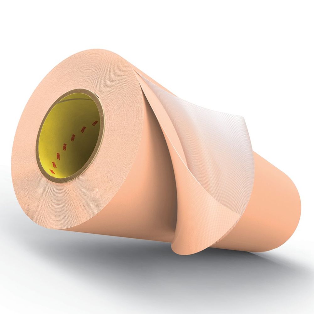 Large master roll of tan 3M medical-grade adhesive film on a white background.
