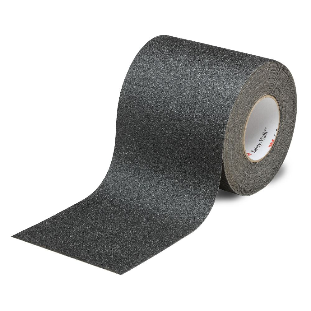 A single wide roll of black 3M Safety-Walk 610 general purpose slip-resistant tread tape unrolling on a clean white background