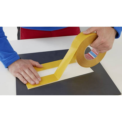 Close-up of the aggressive acrylic adhesive layer on 4970 white PVC tape roll
