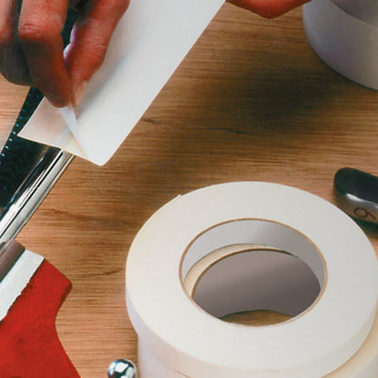Professional application of 591 double-coated flatback paper tape to a metal surface for industrial mounting