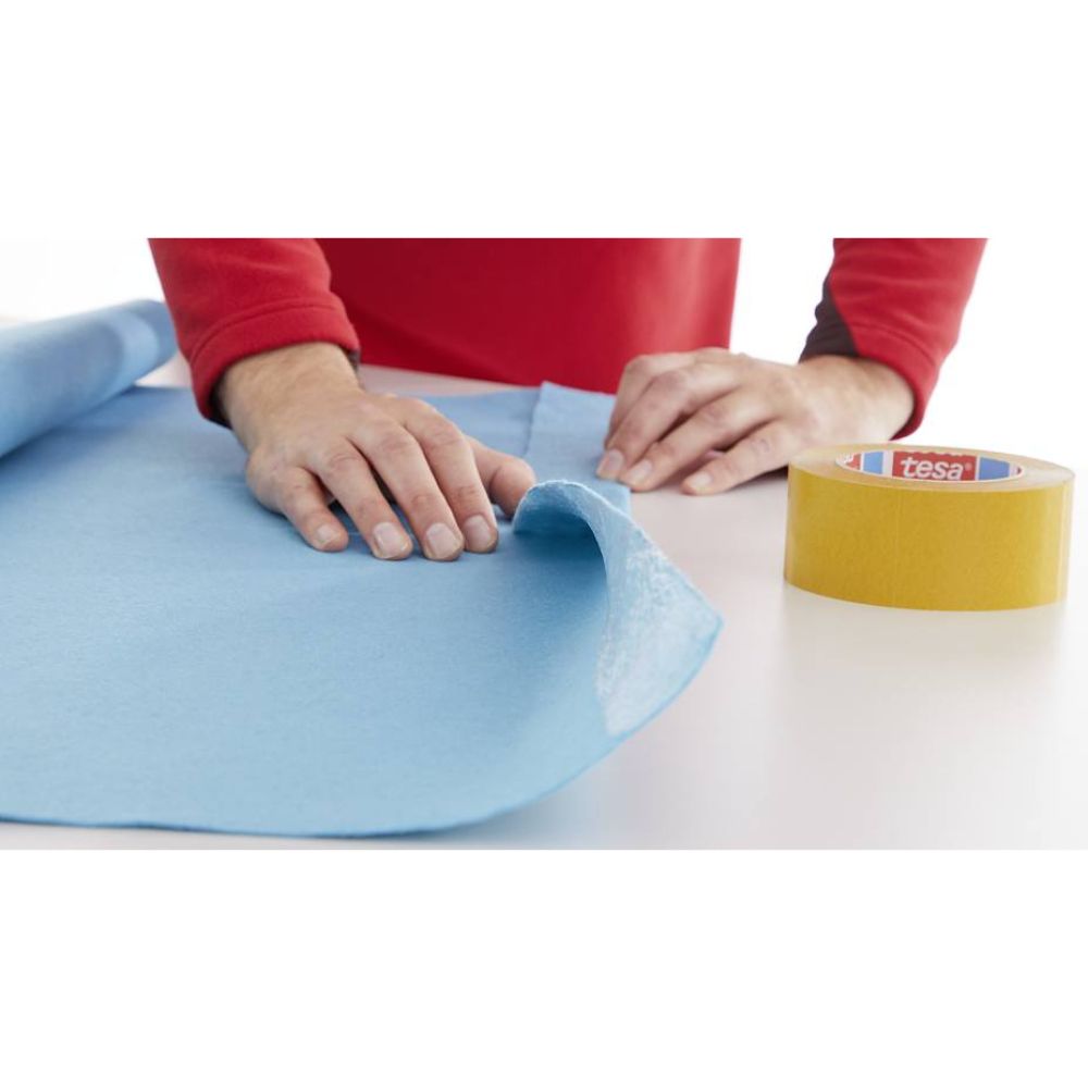 Tesa acrylic double coated clear transfer tape 4900 being applied for fabric bonding and mounting