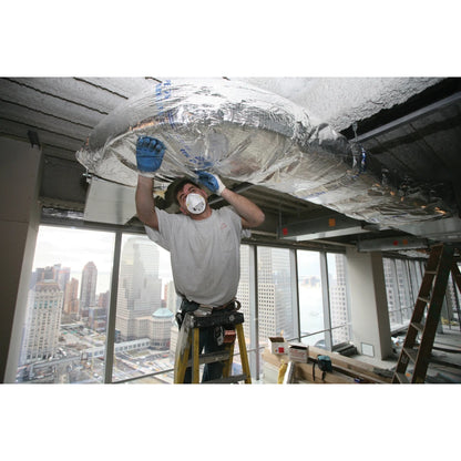 Worker installing CertainTeed SoftTouch Duct Wrap insulation on HVAC ductwork in a commercial building
