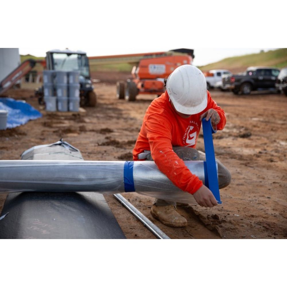 Worker Applying Blue Premium Grade Masking Tape CP27 on Construction Site