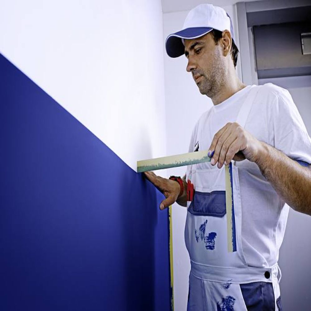 Painter Removing Yellow Precision Masking Tape 4334 After Painting Wall