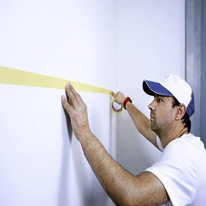 Painter Applying Yellow Precision Mask Painters Tape 4334 on Wall