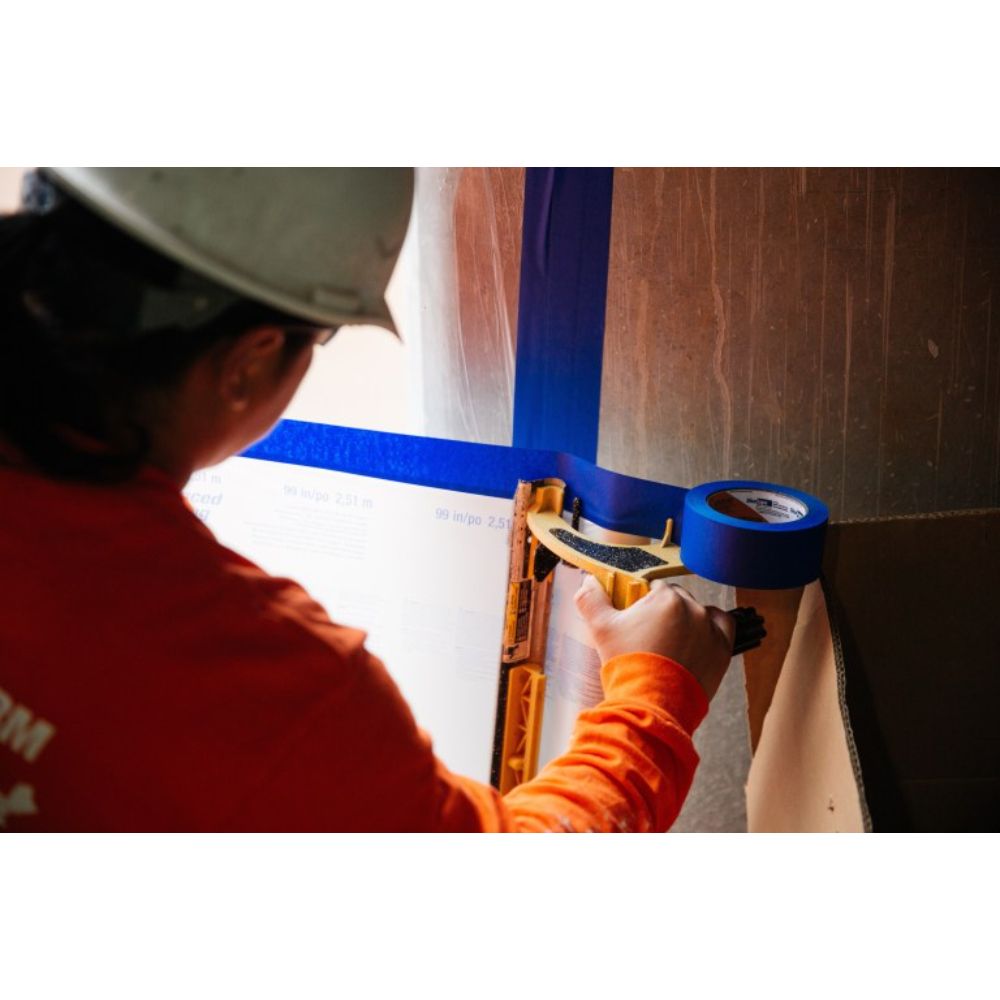 Applying Shurtape CP27 Blue Painters Masking Tape on Wall Surface
