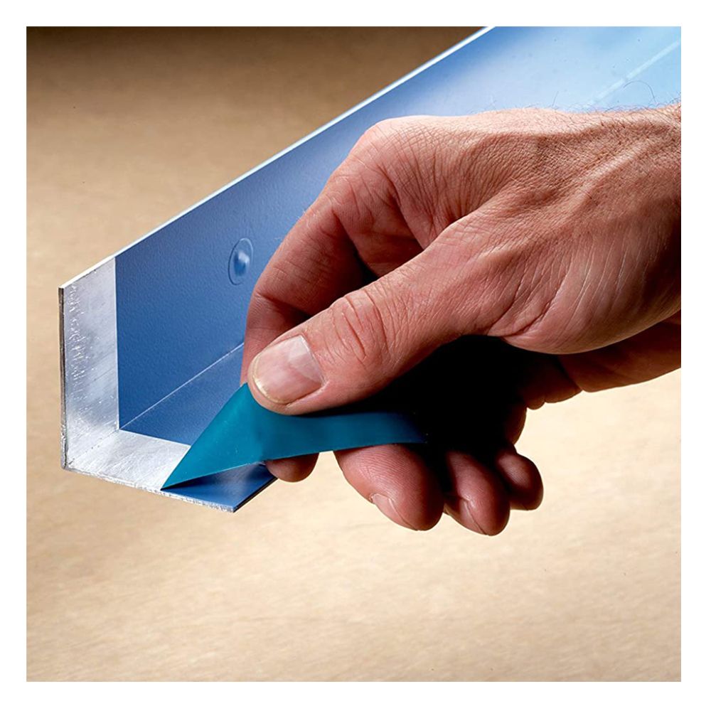 Hand peeling blue polyester masking tape from a metal angle to show clean lines.