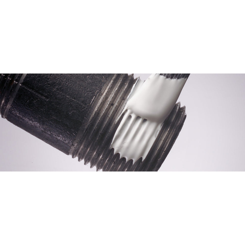 Close-up of white Loctite 567 thread sealant being applied with a brush to metal pipe threads showing even coverage for leak-free sealing of industrial pipe fittings