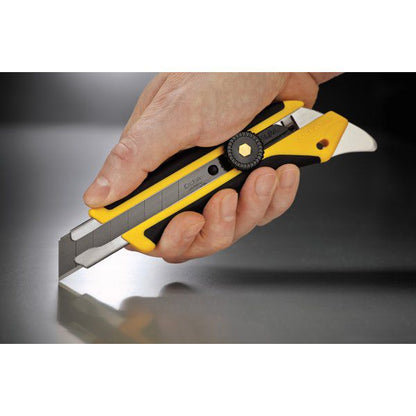 Close up of a hand securely holding an OLFA L-5 fiberglass reinforced utility knife over a metallic surface