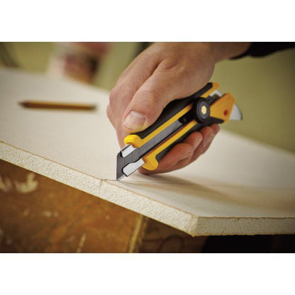 Worker precision scoring a drywall plasterboard sheet along a marked line using an OLFA L-5 utility knife