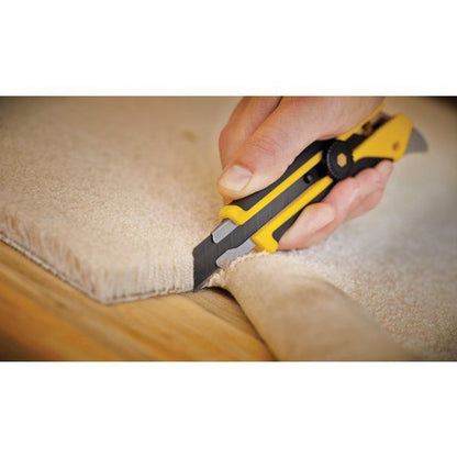 Tradesman using an OLFA L-5 heavy duty knife to cleanly slice through the edge of a beige textured carpet