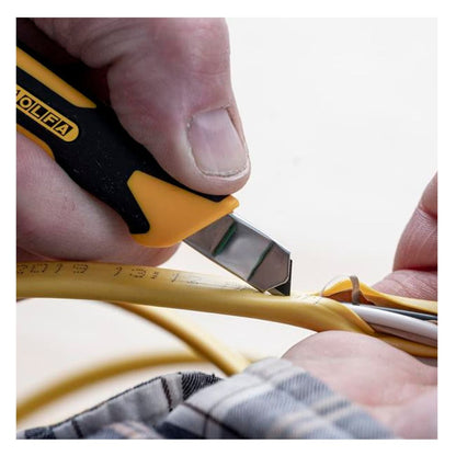 Close up view of OLFA XA-1 utility knife being used to precisely strip insulation from a yellow electric cable