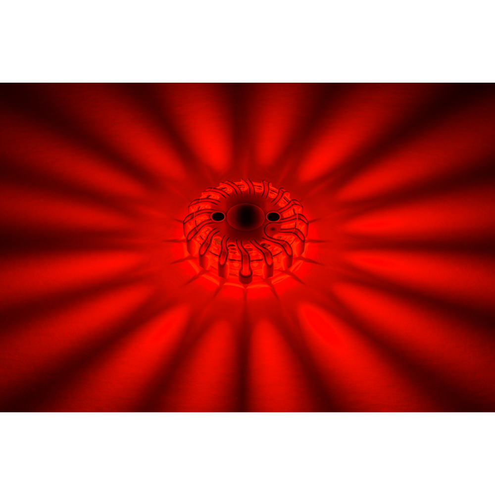 A single LEO red LED safety flare illuminated in the dark showing high-visibility 360-degree light output for traffic safety.
