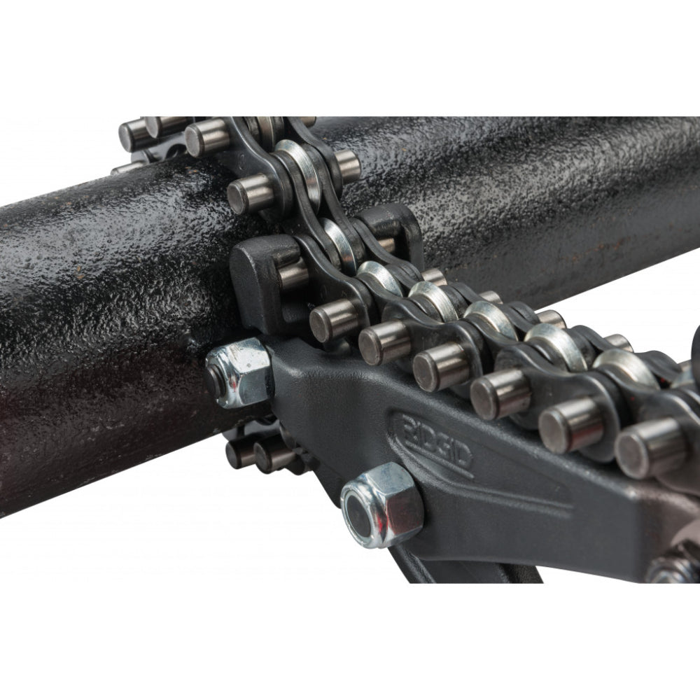 Close-up of RIDGID cutter chain links engaged on black cast iron pipe