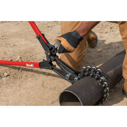 Worker adjusting RIDGID soil pipe cutter tension knob while cutting cast iron pipe