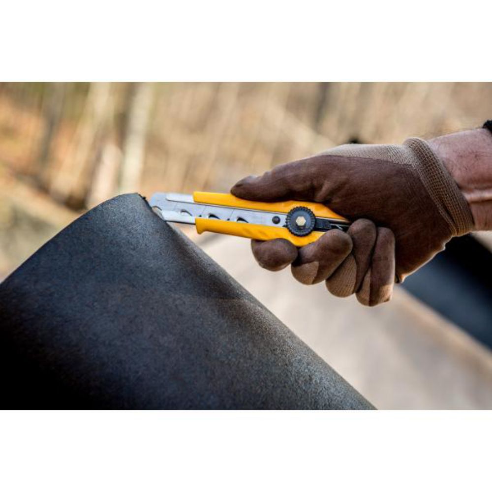 Using the metal guide on an OLFA CL utility knife to safely score a cardboard box flap