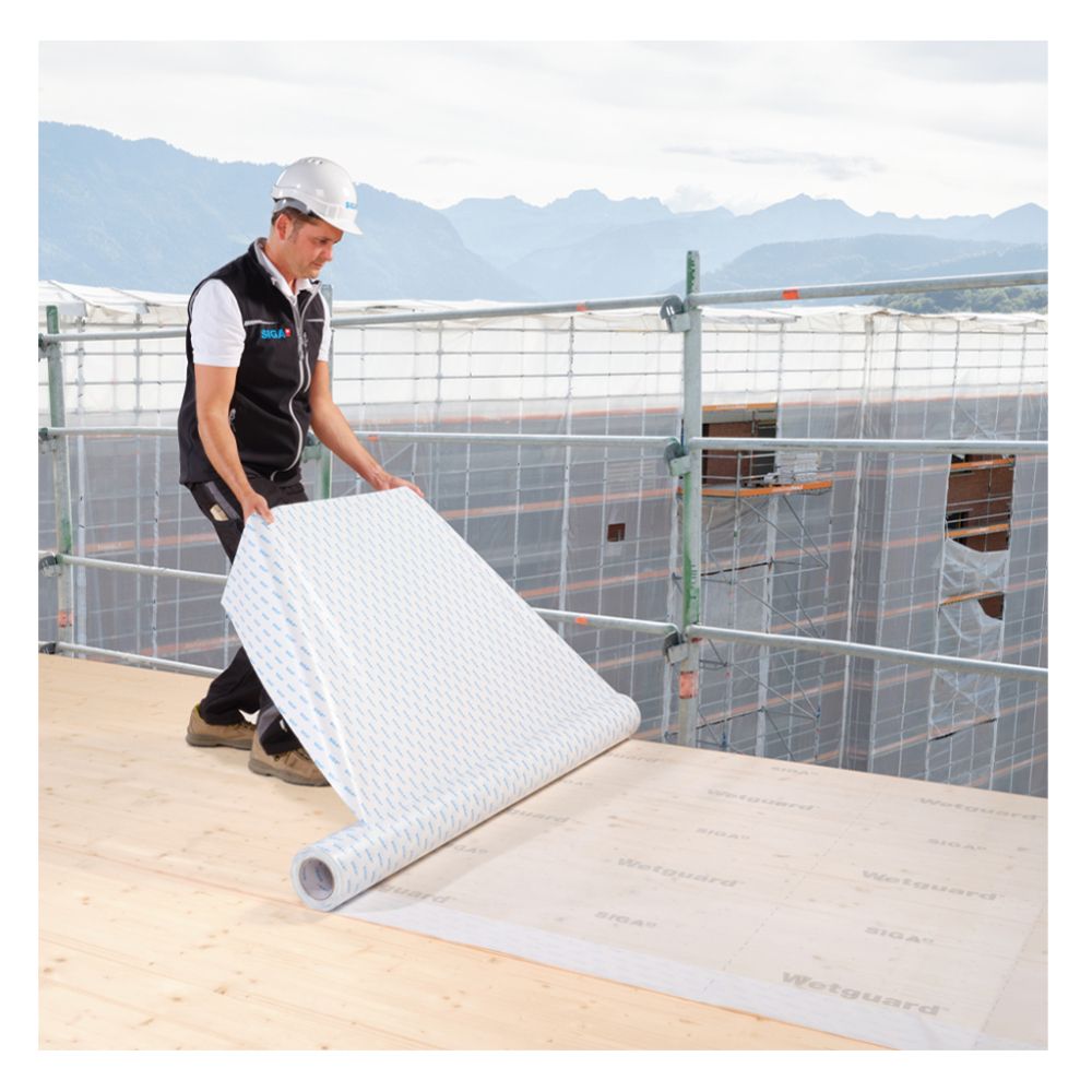 Worker Installing SIGA Wetguard 200 SA Self-Adhered Membrane on Roof Deck