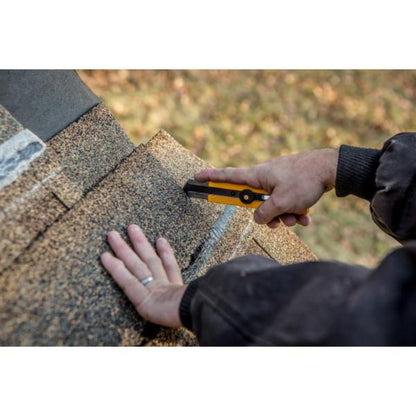Close up of hand using an OLFA SK-16 concealed blade utility knife to cut a thick cardboard box