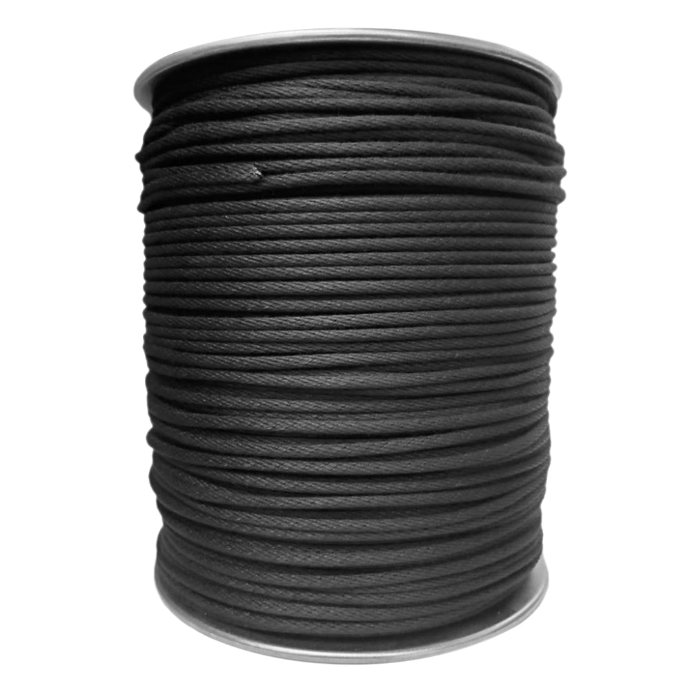 A single large industrial metal spool tightly wound with solid black braided stage cord rigging rope isolated on a white background