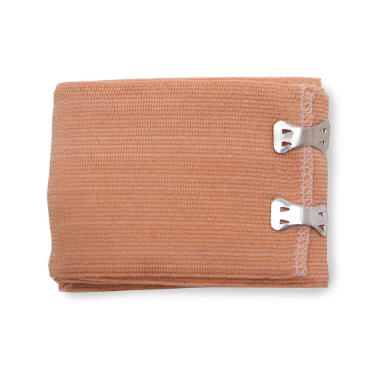 Tan elastic pressure dressing with two metal fastening clips for controlled compression and secure wound management in emergency trauma care.