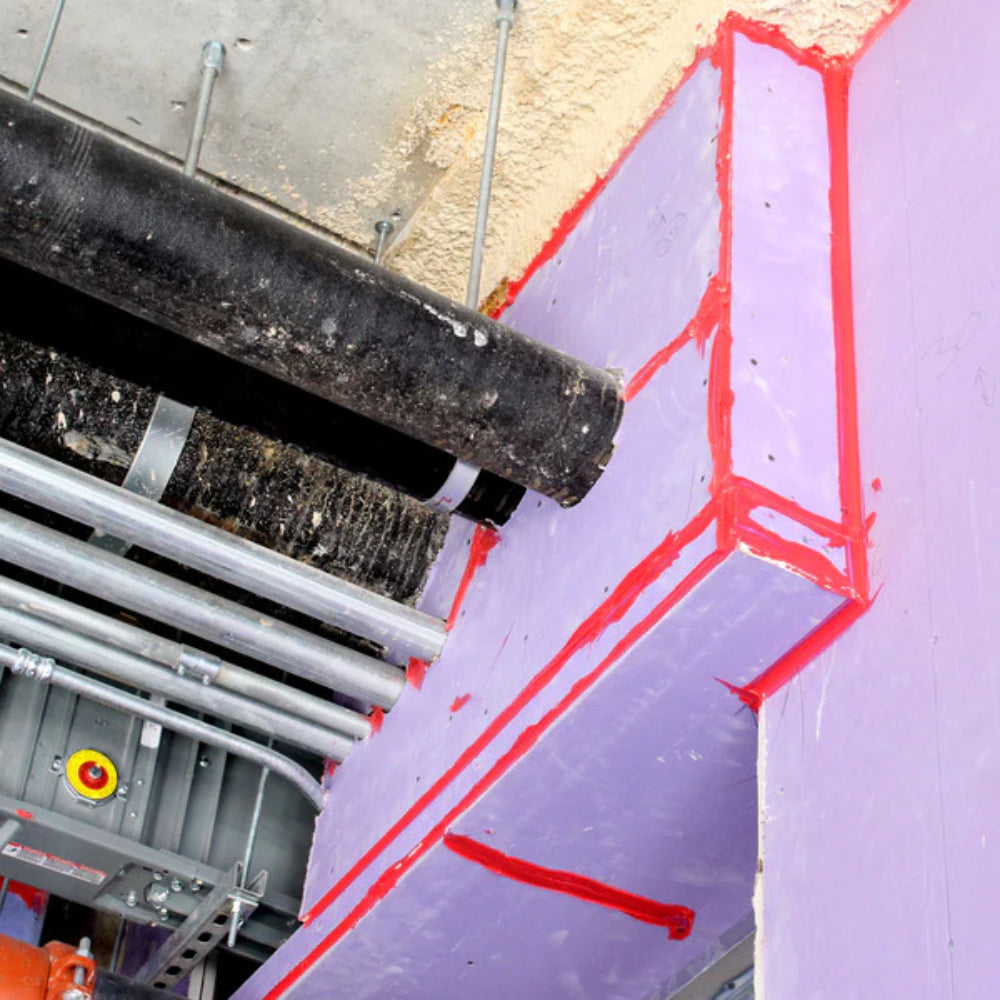 STI LC120 endothermic latex firestop sealant applied to seams and joints of fire-rated insulation board around pipe penetration