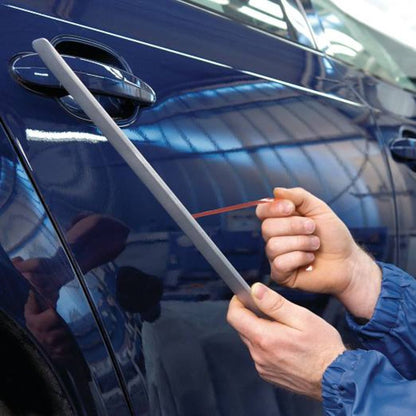 Removing the red MOPP liner from 4965 tape during the installation of protective car body molding