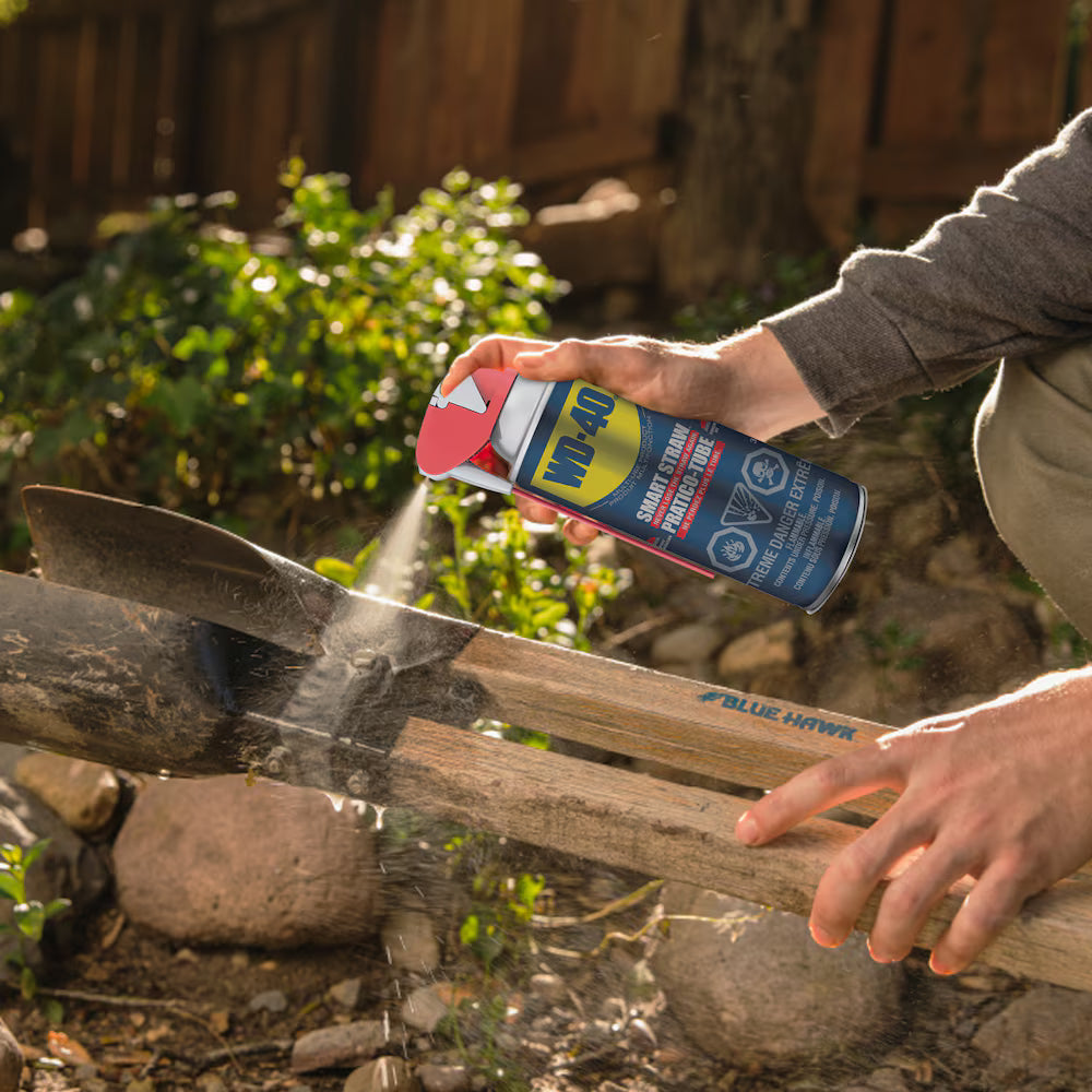 Using WD-40 Multi-Use Product wide spray to protect and lubricate metal garden tools.