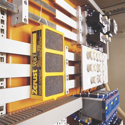 A yellow Zerust VC6-1 VCI vapor capsule hanging inside a commercial electrical control panel to prevent terminal corrosion